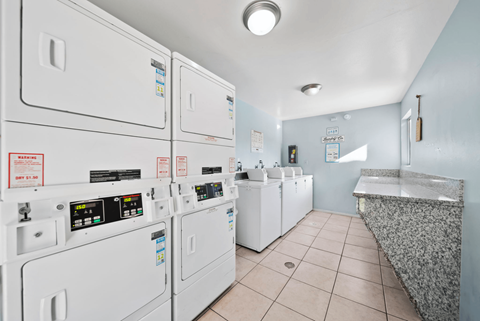 A row of washing machines in a public laundromat.