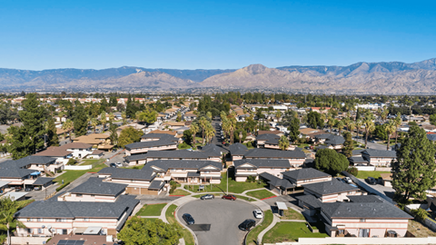 A large, well-maintained residential area with houses and a clear sky.