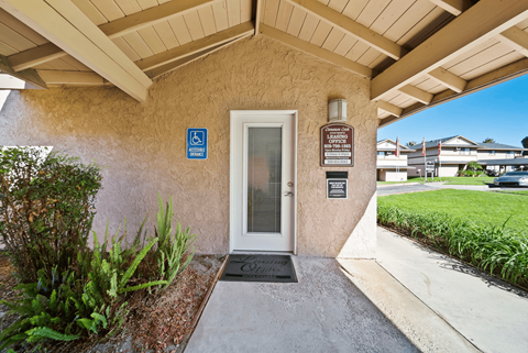 A building entrance with a ramp and a sign indicating it is handicap accessible.