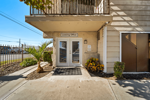 The image shows the front of a building with a sign that reads "Leasing Office".