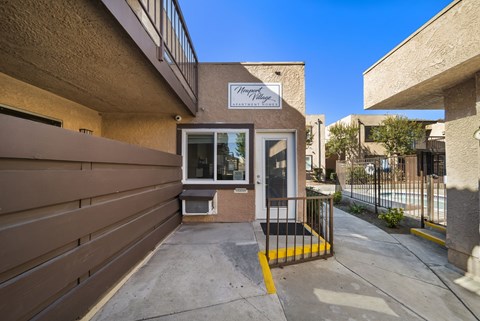 The entrance to a building with a sign that reads "Harvest House.".