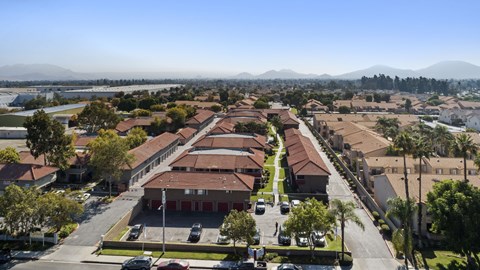A large building complex with a parking lot in front.