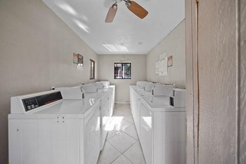 A row of washing machines in a laundromat.