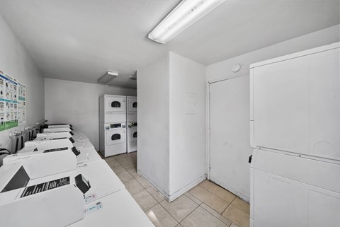 A room with white walls and a white floor with boxes on the table.