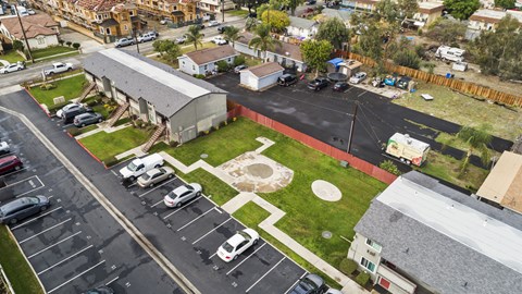 A parking lot with cars and a building in the background.