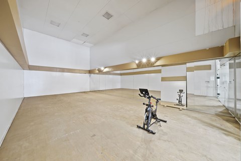 A room with a bicycle leaning against the wall.