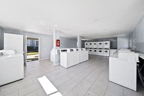 A laundry room with washers and dryers.