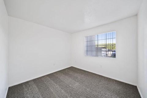 A room with a window and a car parked outside.