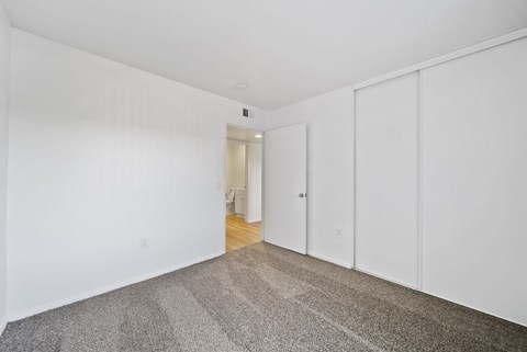 A room with white walls and a carpeted floor.