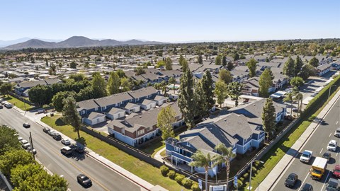 A suburban street with cars and houses.