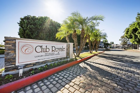 A sign for Club Royale with a phone number and address.
