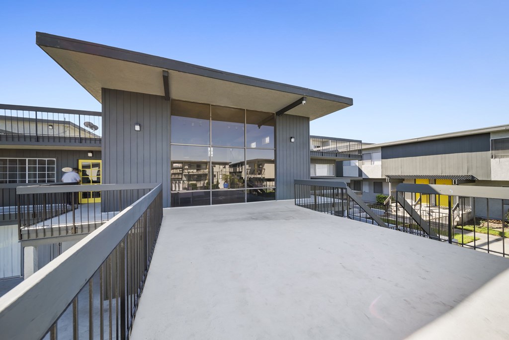 A modern building with a large open space and a metal railing.