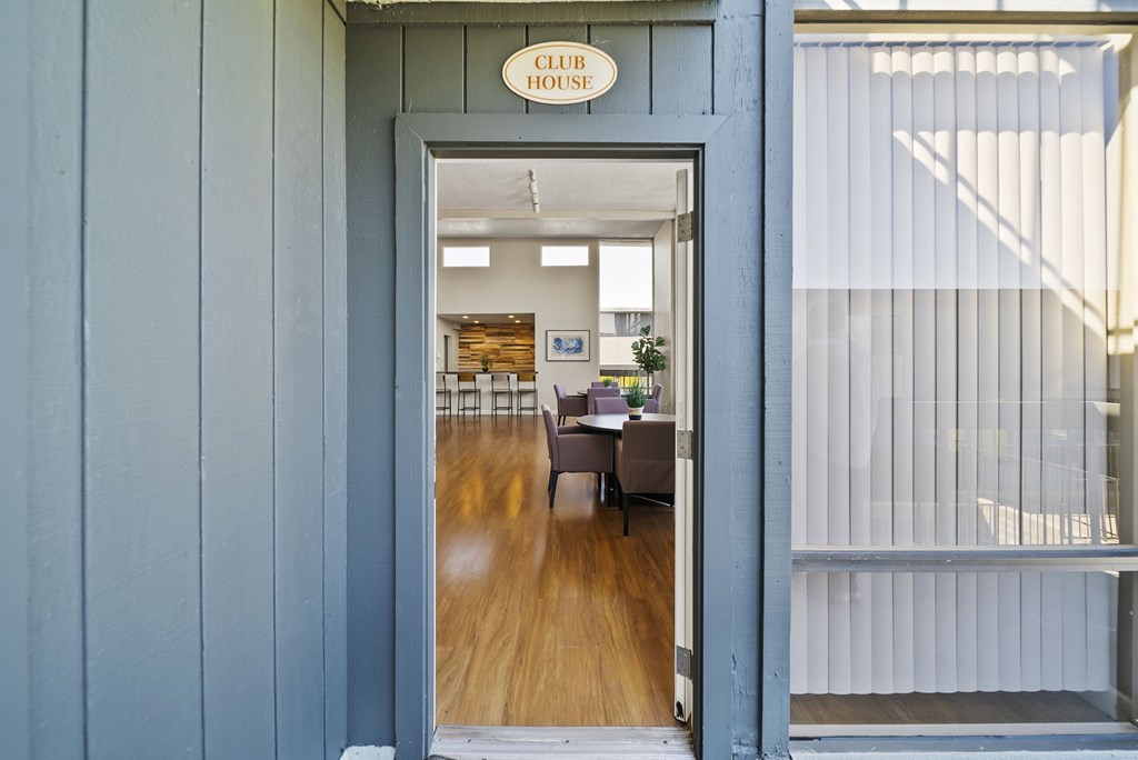 A club house is visible through the doorway.