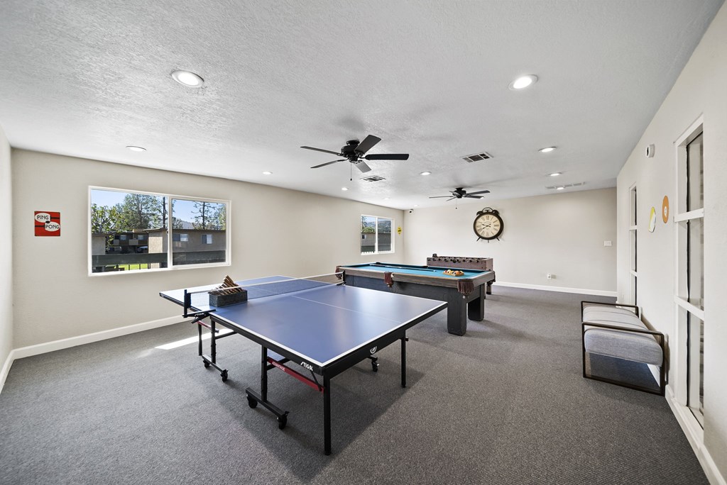 A room with a pool table and a ping pong table.
