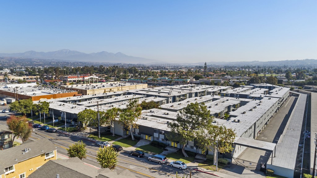 A large parking lot with a mountain range in the background.