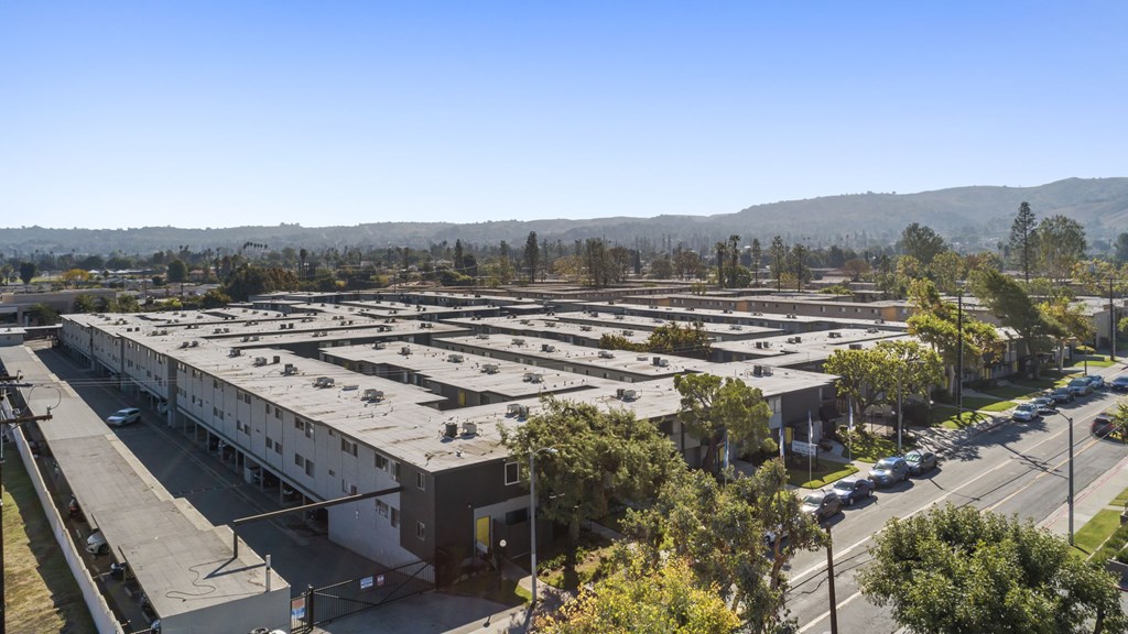 A parking lot with a building in the background.