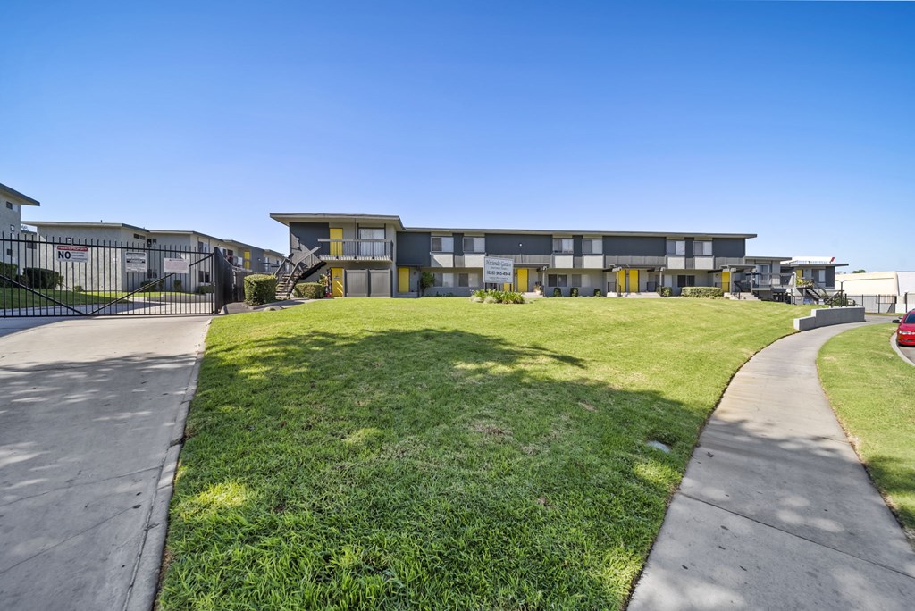 A modern building with a green lawn in front.