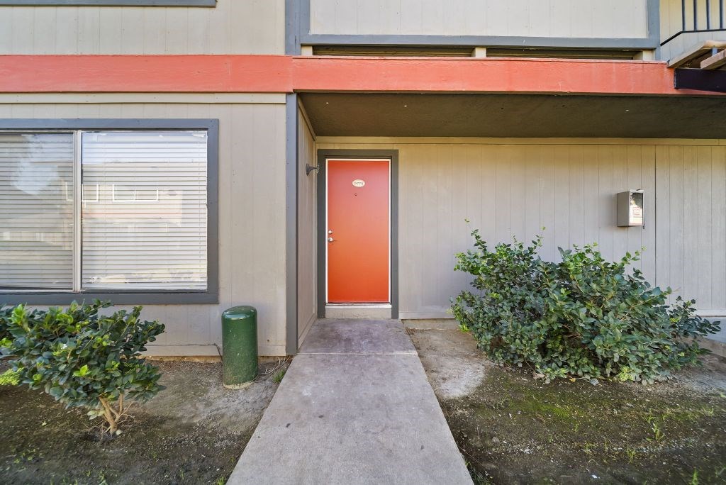 A red door is on the side of a building.