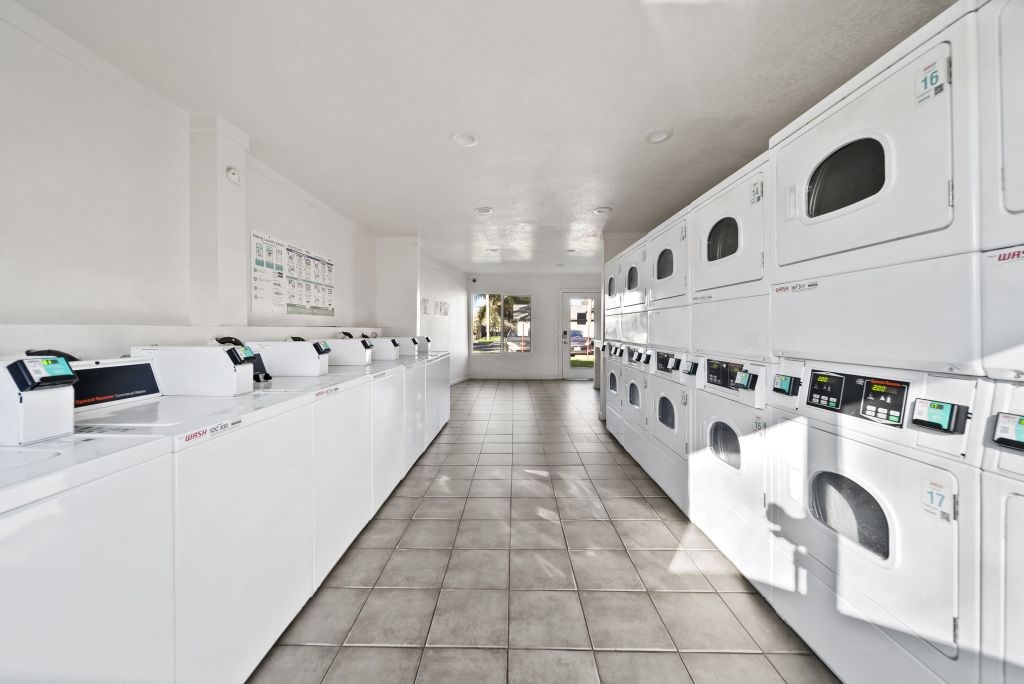 A row of washing machines in a laundromat.