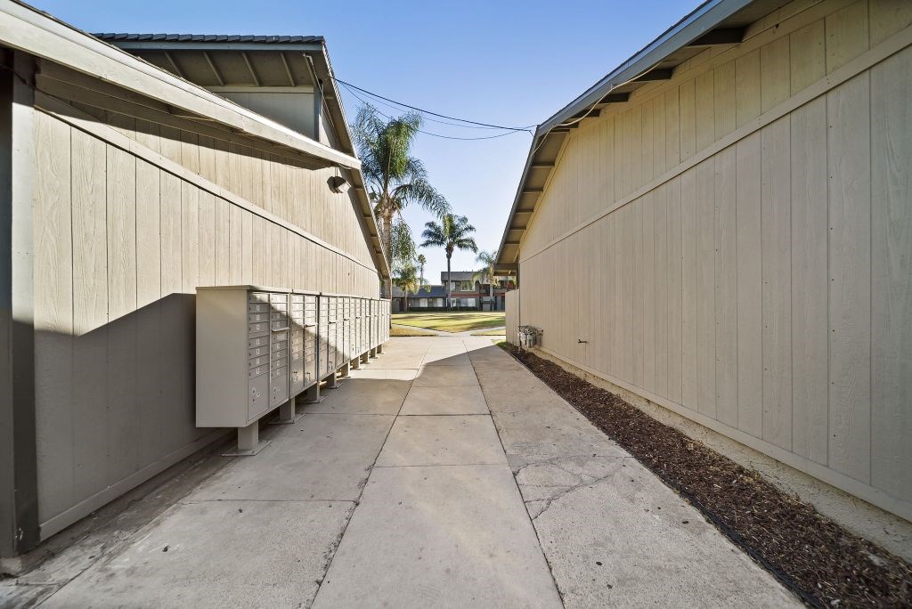 A long concrete walkway between two buildings.