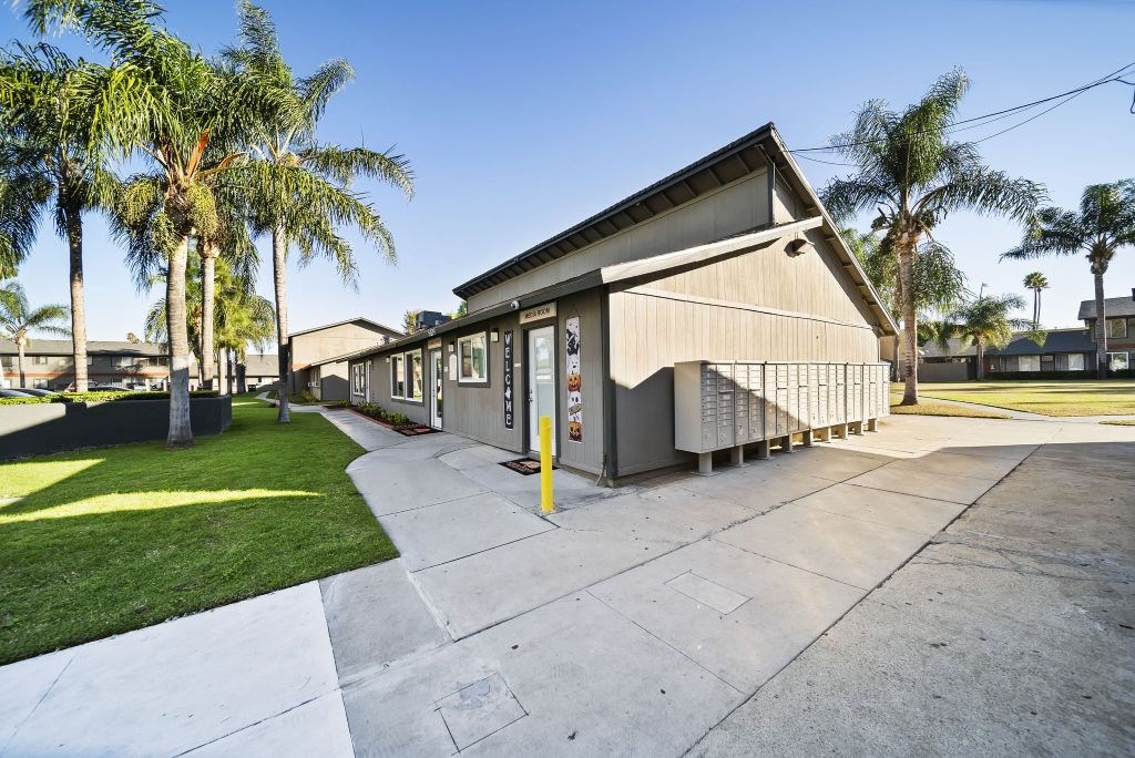 A building with a concrete walkway in front of it.