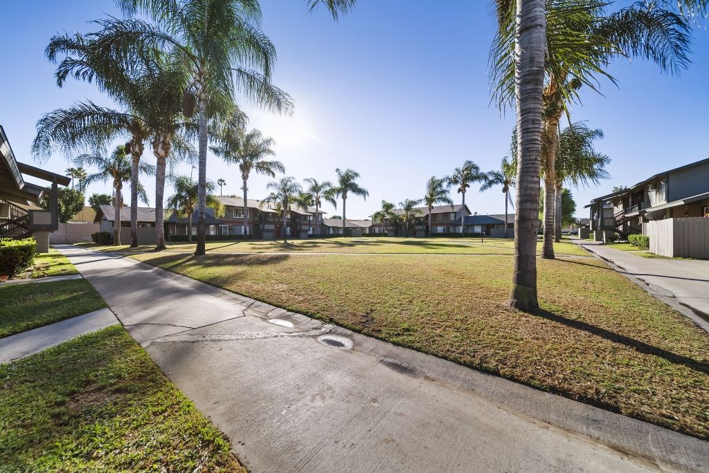 A sunny day in a residential area with a clear blue sky.