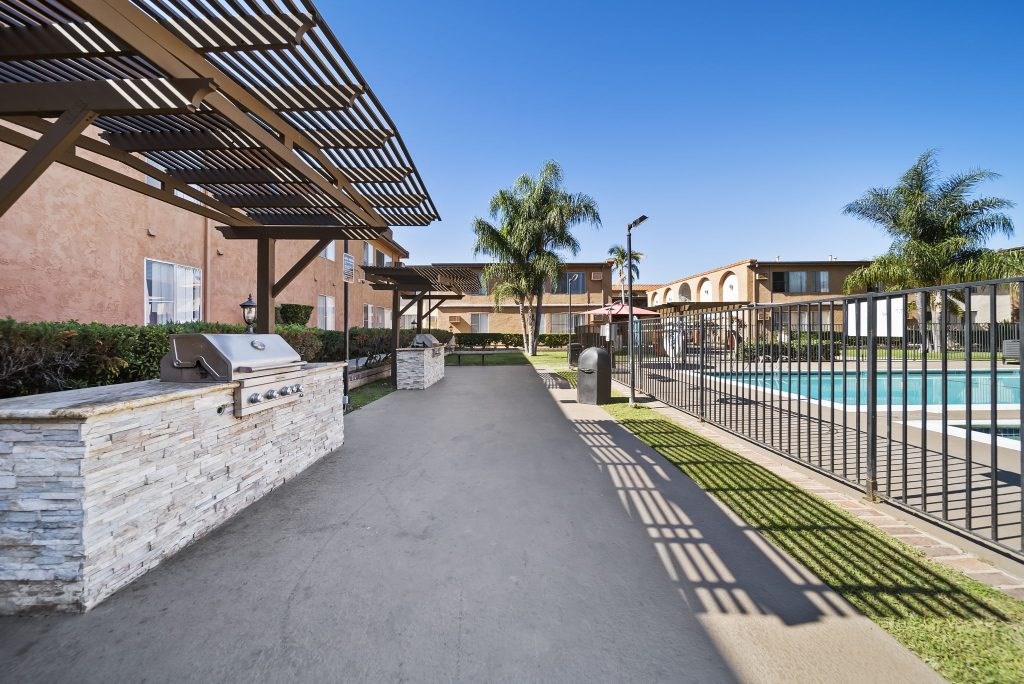A long concrete walkway leads to a pool area.