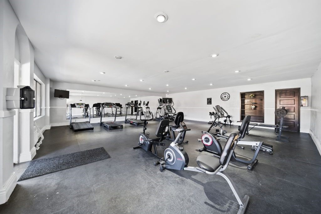 A spacious home gym with a variety of exercise equipment.