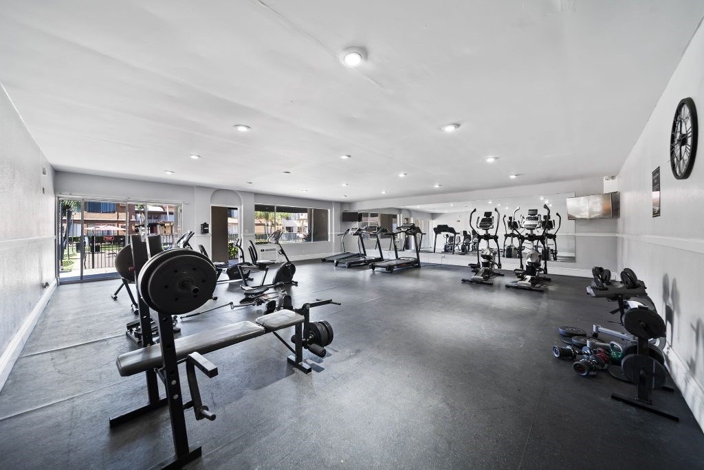 A gym with a variety of exercise equipment.