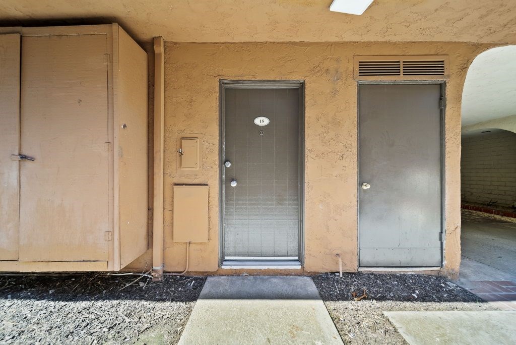A building with a grey door and a brown door.