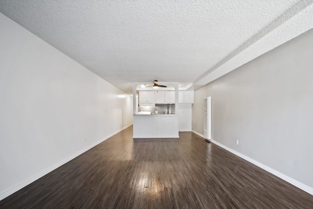 A room with wooden floors and white walls.
