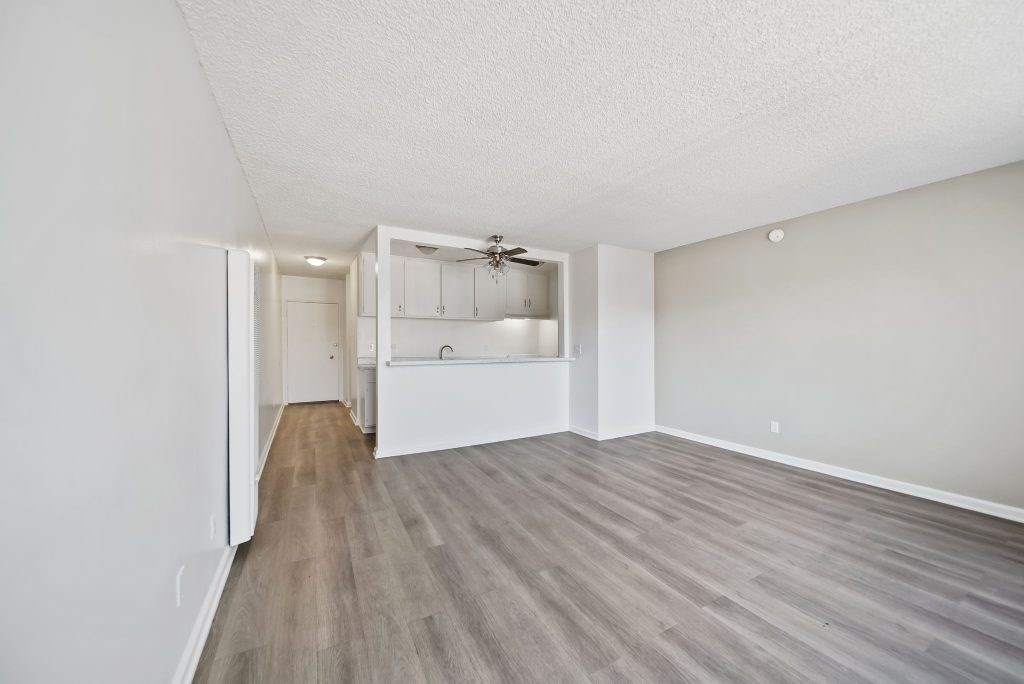 A room with a ceiling fan and a built-in cabinet.