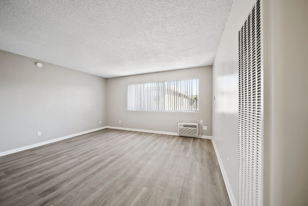 A room with a window and a radiator on the wall.