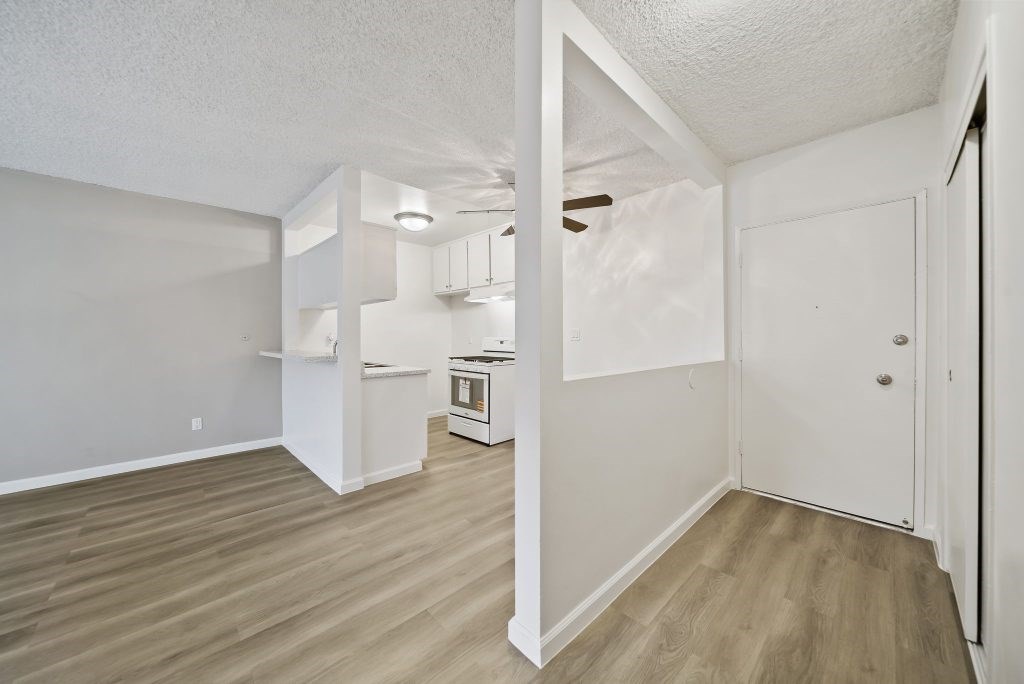 A kitchen area with a white cabinet and a white oven.
