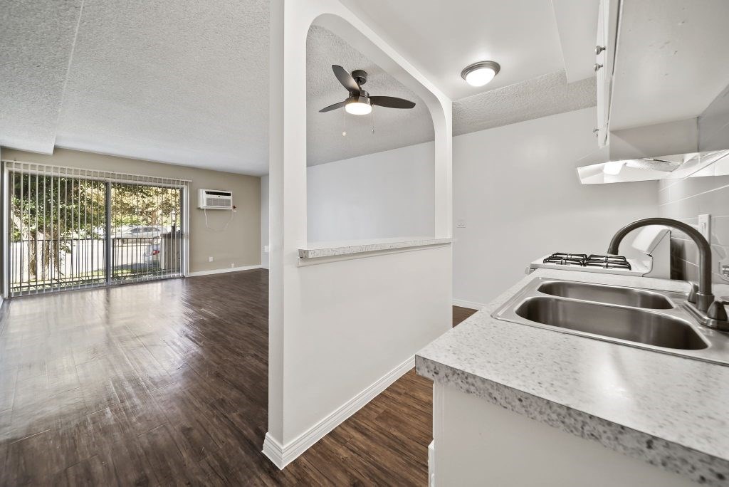 A kitchen with a sink and a fan.