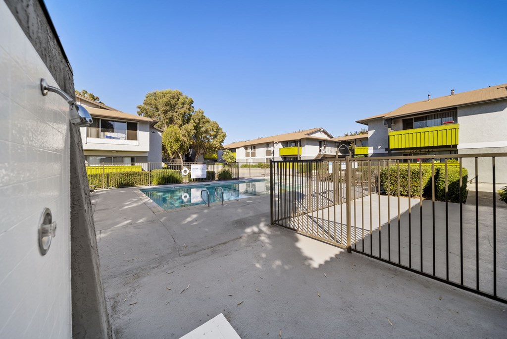 A black gate blocks the way to a pool.