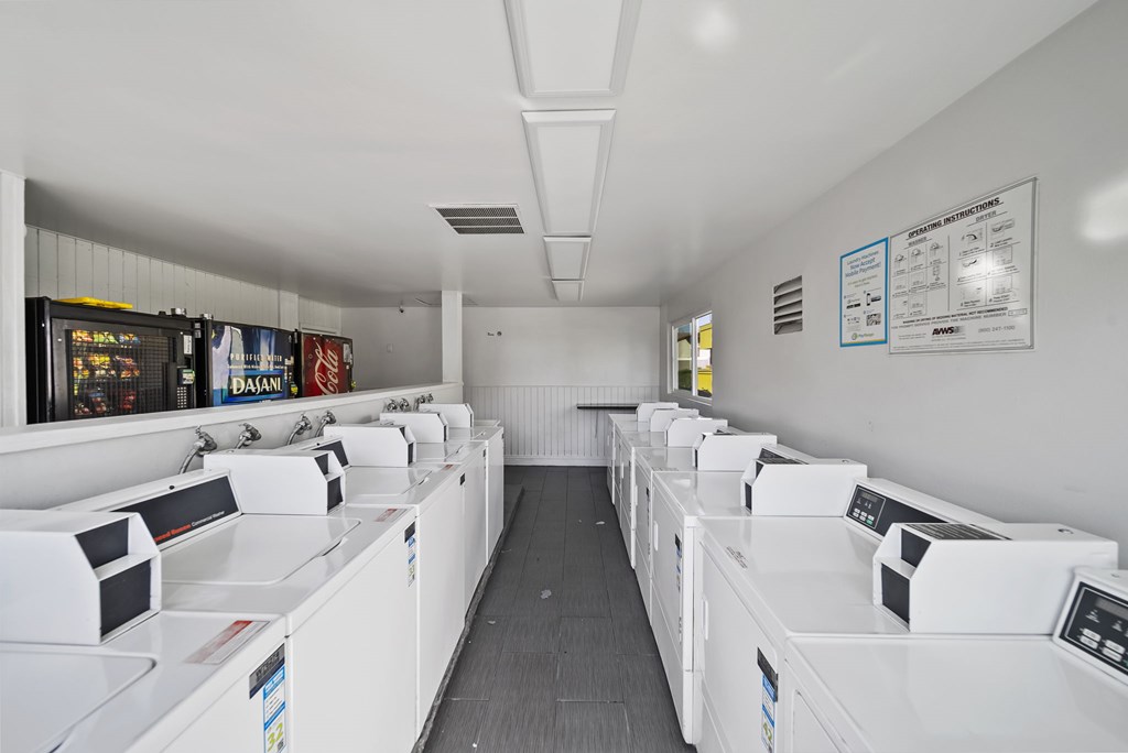 A laundromat with rows of washers and dryers.