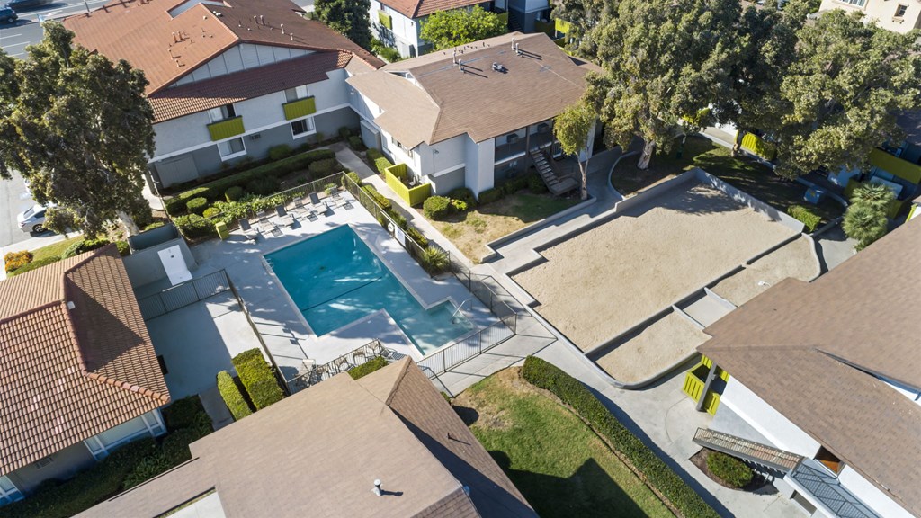 A swimming pool surrounded by houses.