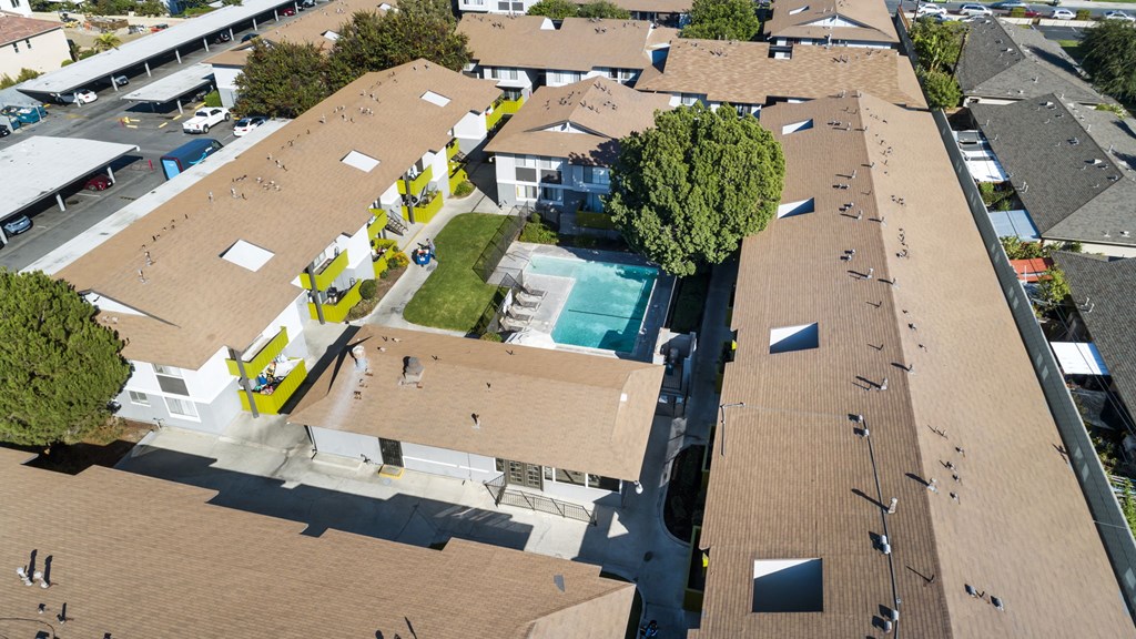 A view of a building with a pool in the middle.