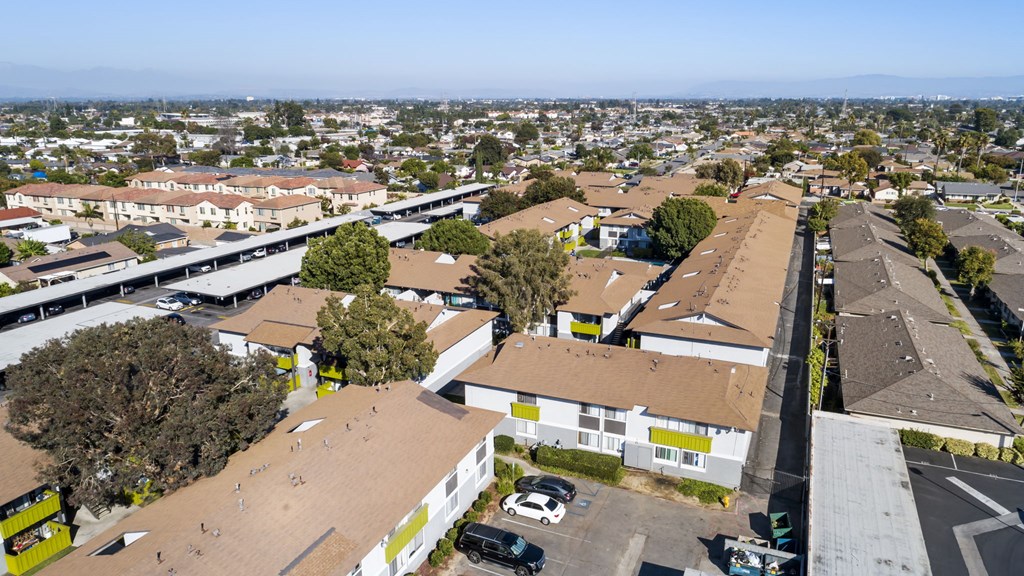 A parking lot is in the foreground of a city scene.