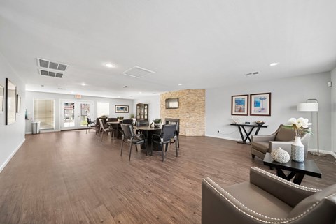 A spacious living room with a dining table and chairs.
