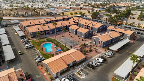 A large building complex with a pool in the middle.