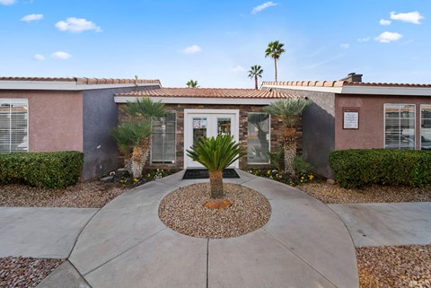 A house with a palm tree in front.
