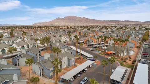 A residential area with houses and parked cars.