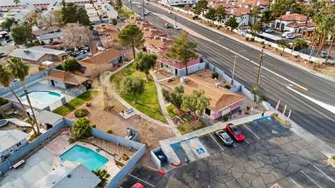 A parking lot with cars and a pool in the foreground.
