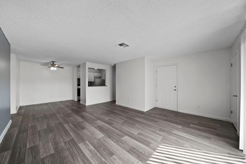 A room with a ceiling fan and a door.