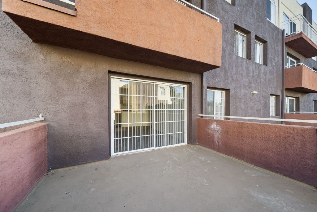 A building with a brown wall and a white gate.