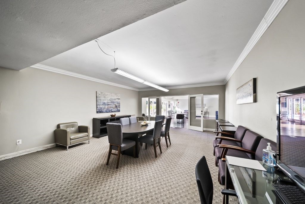 A conference room with a table and chairs.