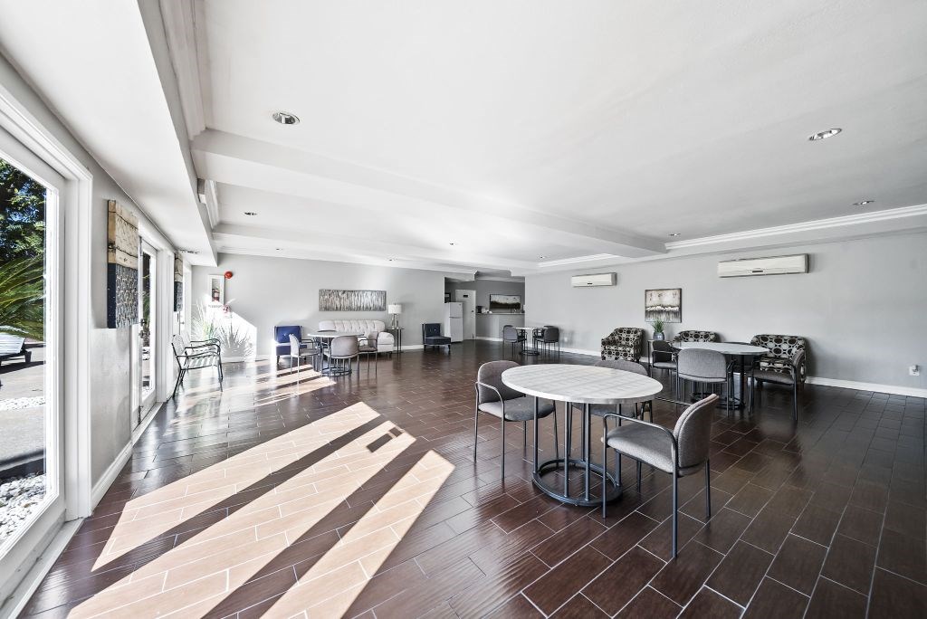 A modern dining room with a table set for six.