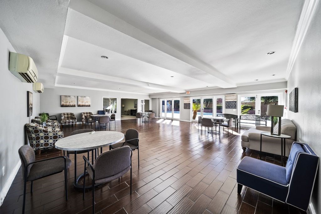 A spacious room with a round table and chairs.